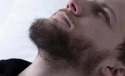 Close-up of a man's lower face with a beard and mustache.