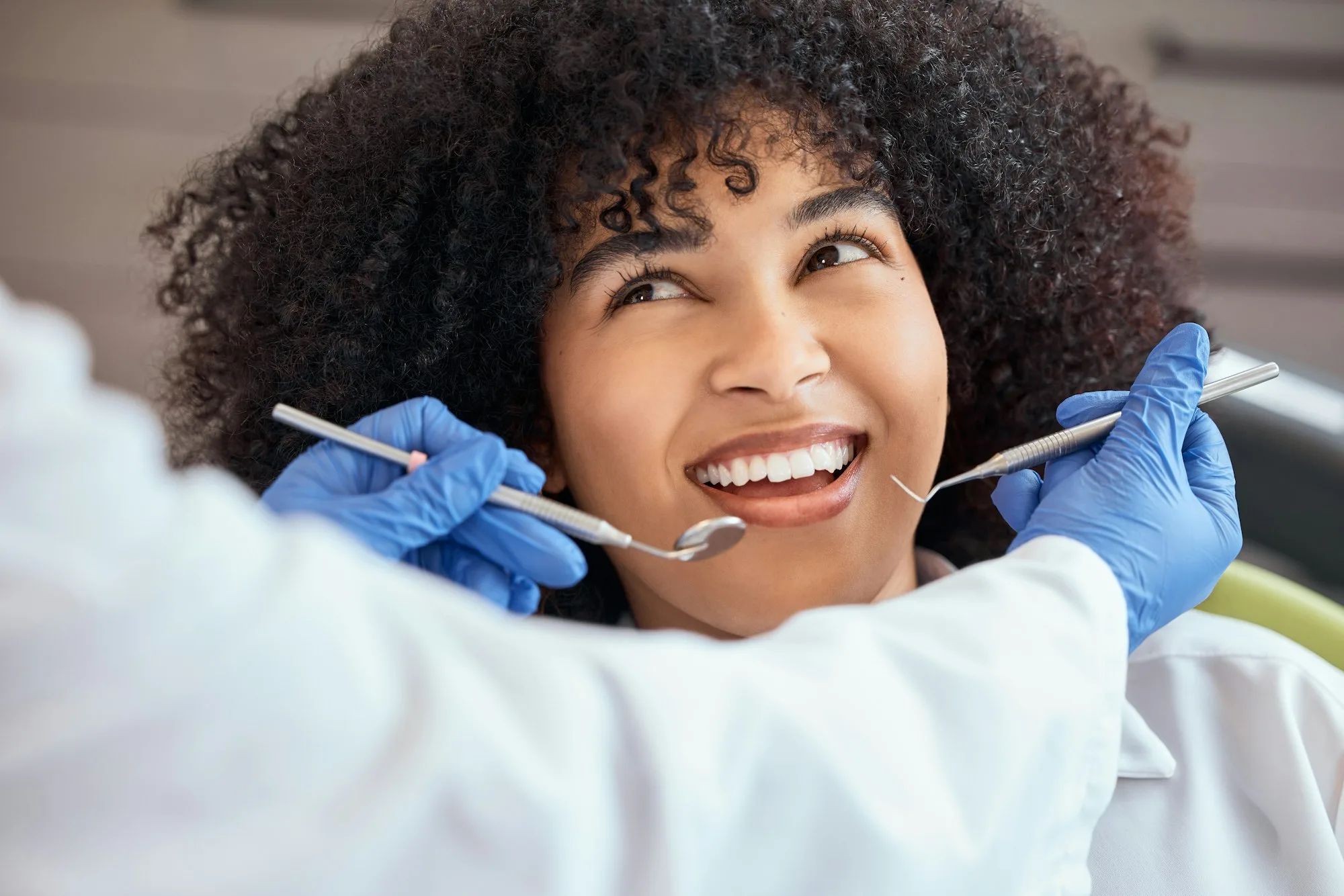 A woman smiling during a dental checkup.